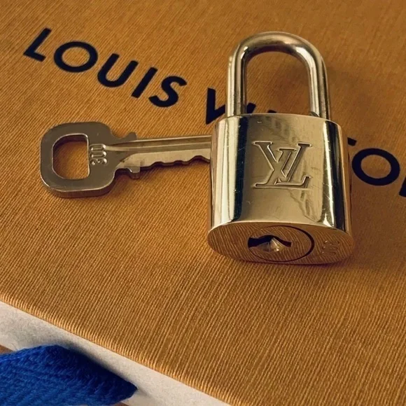 NEAR MINT Louis Vuitton lock and key set.